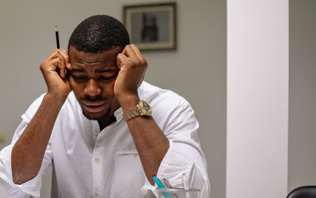 stressed man with hands on forehead